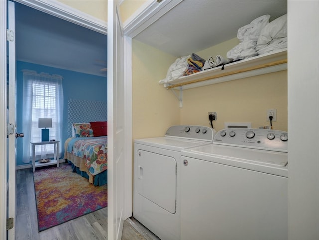 laundry area featuring light wood-type flooring and washing machine and dryer