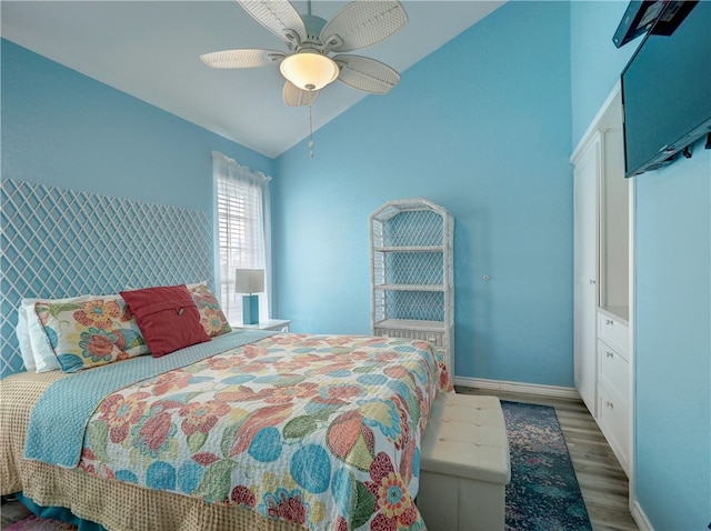 bedroom featuring ceiling fan, dark hardwood / wood-style floors, and vaulted ceiling