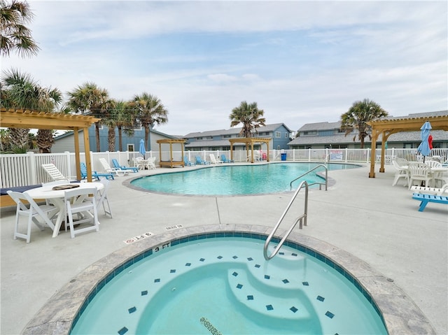 view of pool featuring a community hot tub, a patio, and a pergola