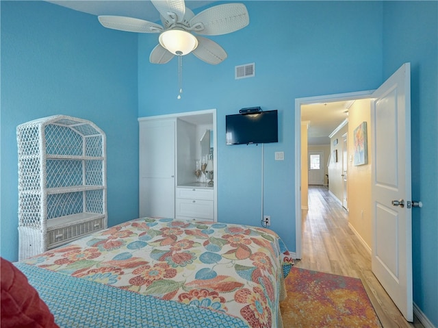 bedroom with light hardwood / wood-style floors and ceiling fan