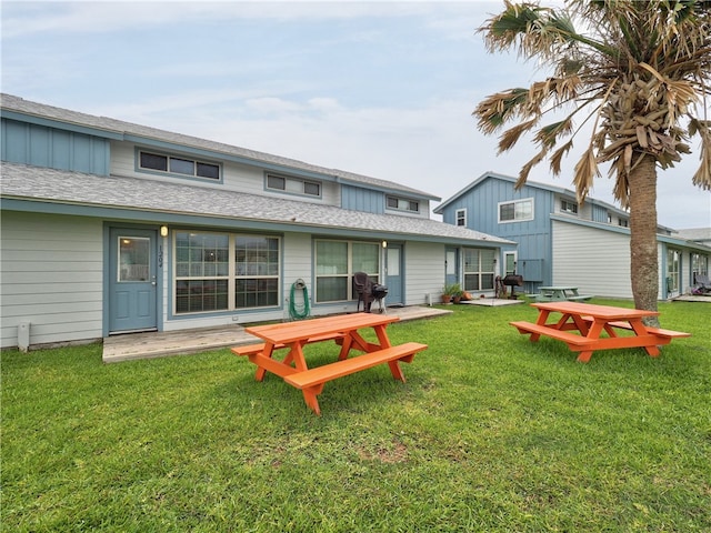 back of house featuring a patio and a lawn