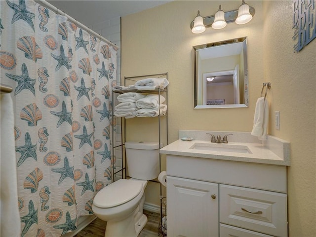 715 Beach Access Road 1a 1204, Port Aransas, TX 78373 - full bathroom with toilet, vanity, a shower with shower curtain, and wood finished floors