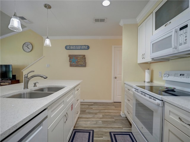 kitchen featuring crown molding, hanging light fixtures, sink, white cabinets, and white appliances