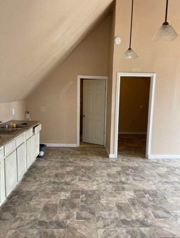 additional living space with lofted ceiling and sink