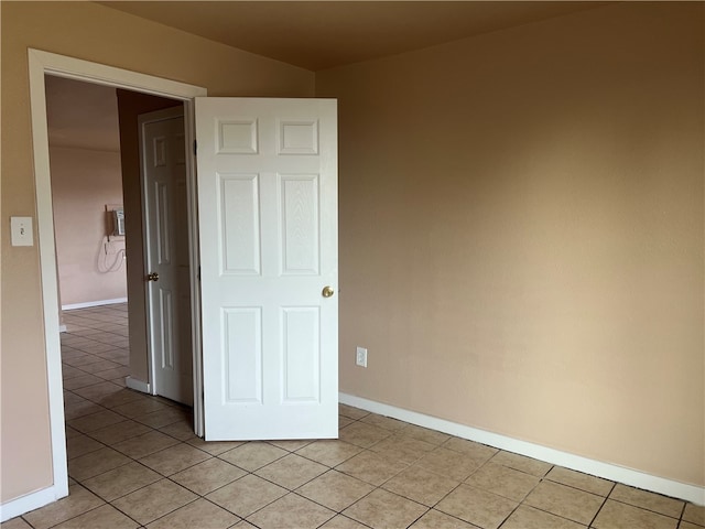 unfurnished room with light tile patterned floors