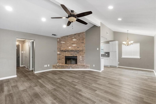 2718 Wind Rock Dr, Corpus Christi, TX 78410 - unfurnished living room featuring a ceiling fan, a chandelier, light wood finished floors, baseboards, and recessed lighting