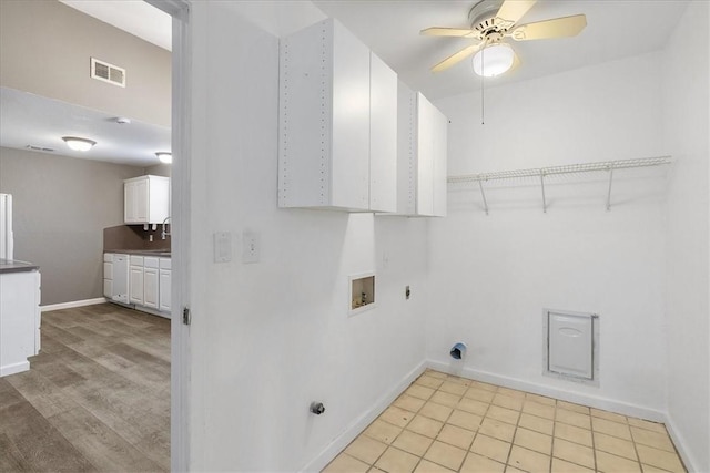 2718 Wind Rock Dr, Corpus Christi, TX 78410 - laundry room featuring hookup for an electric dryer, cabinet space, washer hookup, ceiling fan, and baseboards
