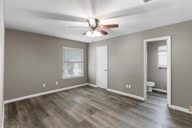 2718 Wind Rock Dr, Corpus Christi, TX 78410 - unfurnished bedroom with multiple windows, wood finished floors, and ensuite bathroom