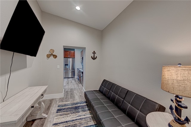 living room with light hardwood / wood-style flooring and lofted ceiling