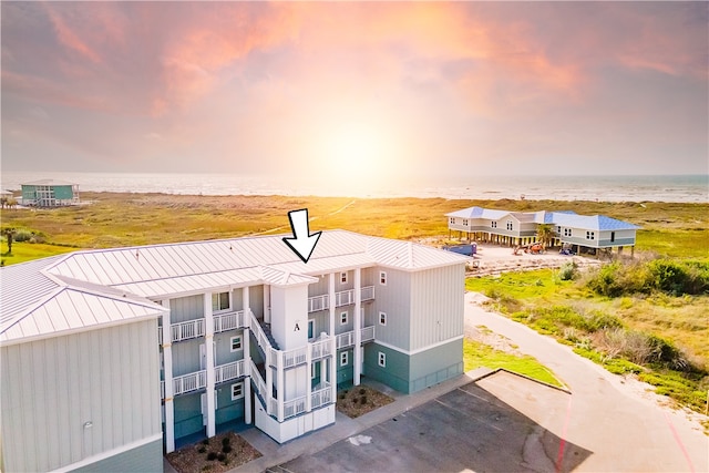 exterior space featuring a view of the beach and a water view