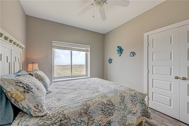 bedroom with light hardwood / wood-style floors and ceiling fan