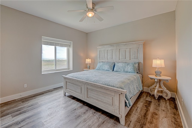 bedroom with light wood-type flooring and ceiling fan