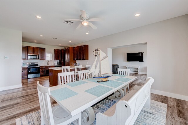 dining area featuring hardwood / wood-style floors and ceiling fan