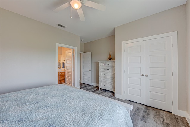 bedroom featuring a closet, wood-type flooring, ceiling fan, and ensuite bathroom