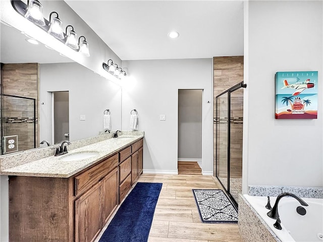 bathroom with vanity and separate shower and tub