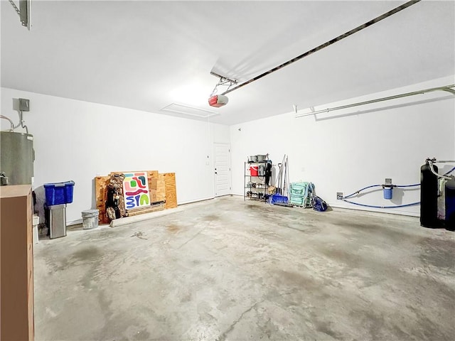 garage with water heater and a garage door opener