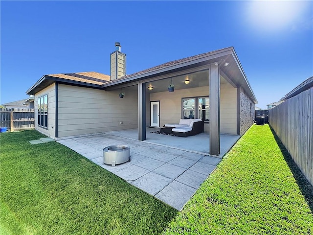 back of property featuring a yard and a patio