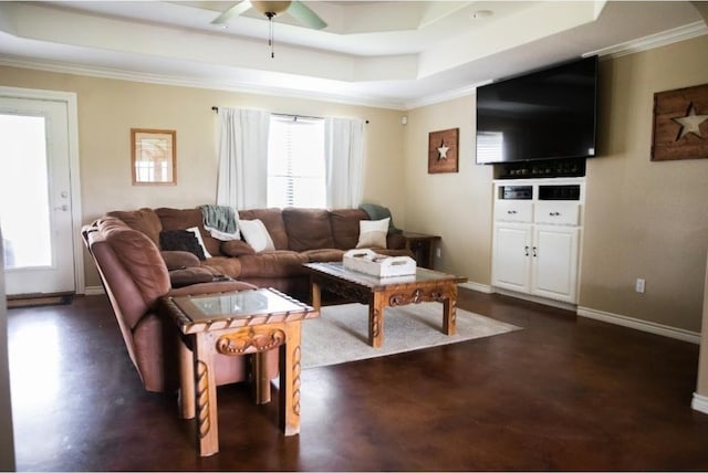 living room featuring ceiling fan, crown molding, and a tray ceiling