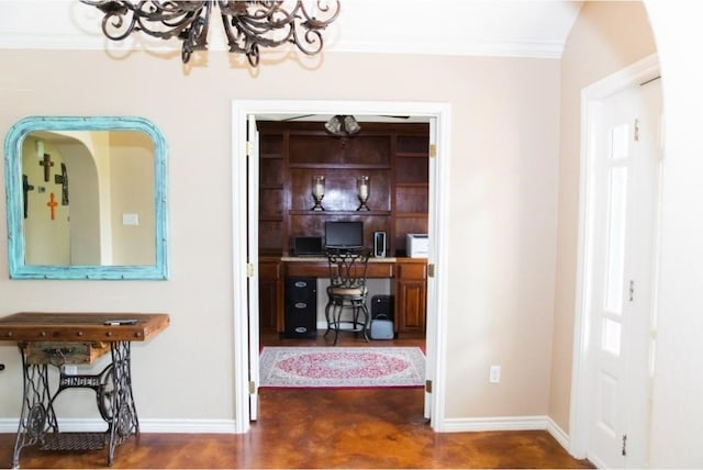 entryway with dark wood-type flooring, a chandelier, and ornamental molding