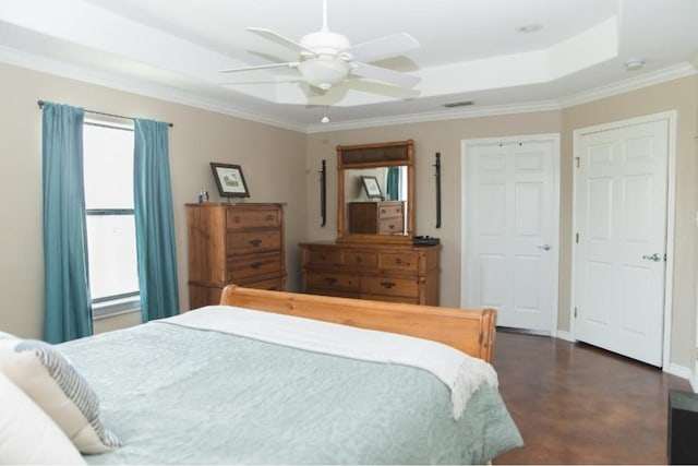 bedroom featuring ornamental molding, ceiling fan, and a tray ceiling