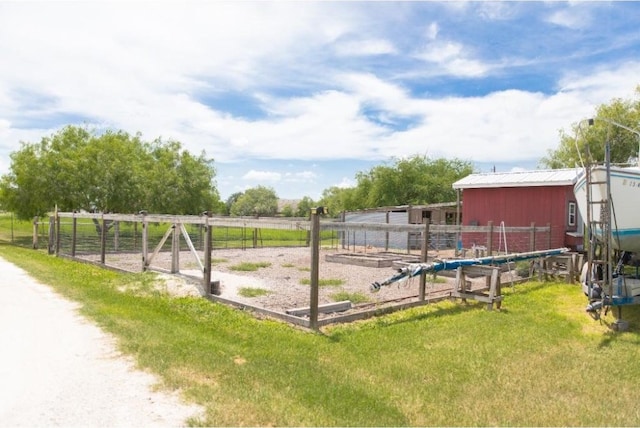 view of yard with an outbuilding and a rural view