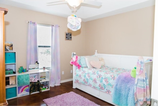 bedroom with ceiling fan and dark hardwood / wood-style flooring