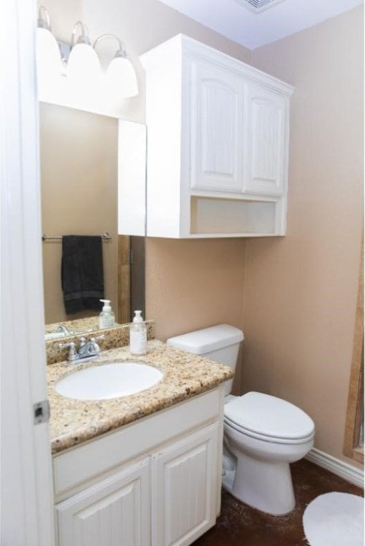 bathroom featuring vanity and toilet