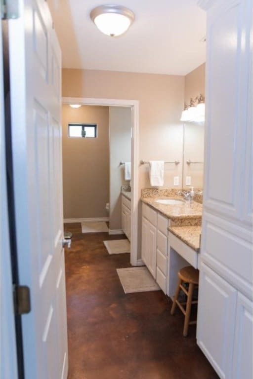 bathroom featuring vanity, concrete floors, and toilet