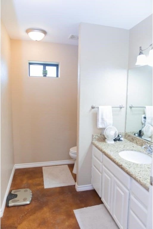 bathroom with toilet and vanity