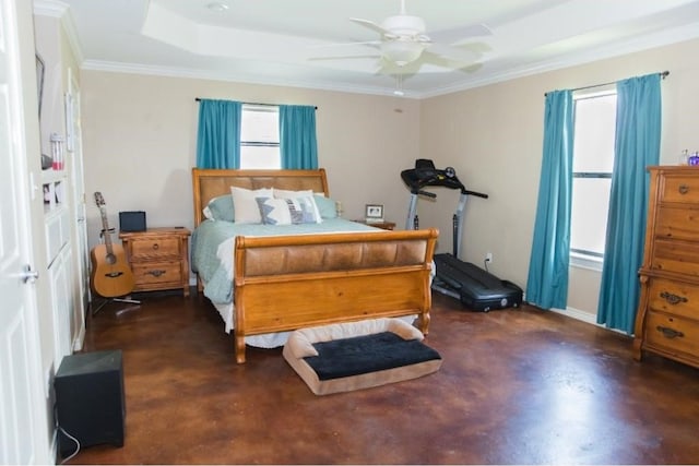 bedroom featuring ceiling fan, crown molding, and a tray ceiling