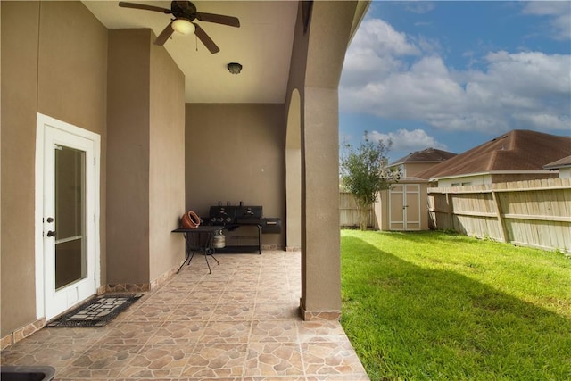 6825 Old Square Dr, Corpus Christi, TX 78414 - fenced backyard with ceiling fan, a patio area, and a storage unit