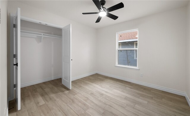 unfurnished bedroom featuring a closet, ceiling fan, and light wood-type flooring