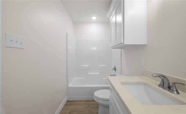 full bathroom featuring vanity, wood-type flooring, shower / tub combination, and toilet