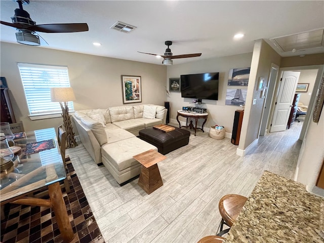 living room featuring light hardwood / wood-style floors and ceiling fan