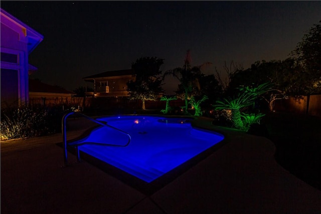 7906 Valtourmanche Dr, Corpus Christi, TX 78414 - pool at night featuring a fenced backyard