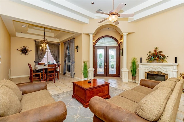 7906 Valtourmanche Dr, Corpus Christi, TX 78414 - living area with a raised ceiling, ornate columns, tile patterned flooring, french doors, and a ceiling fan