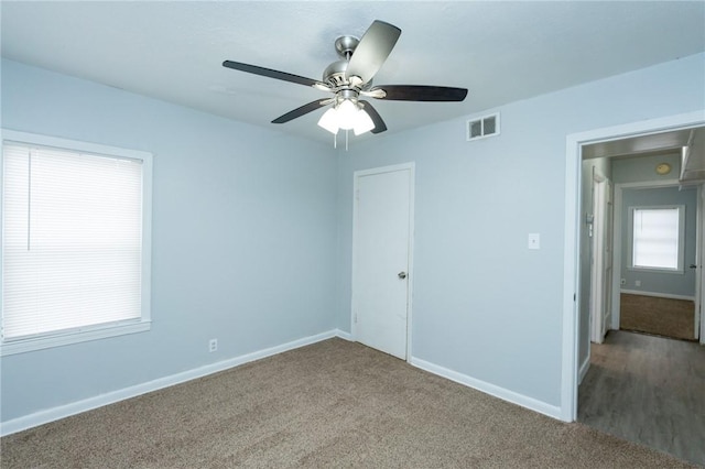 spare room featuring ceiling fan and carpet