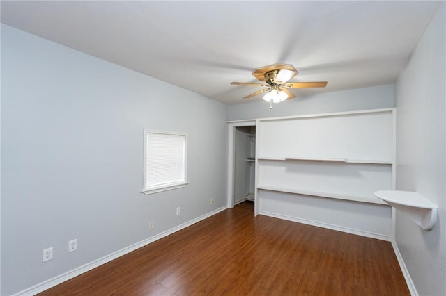 unfurnished bedroom with ceiling fan and dark hardwood / wood-style flooring