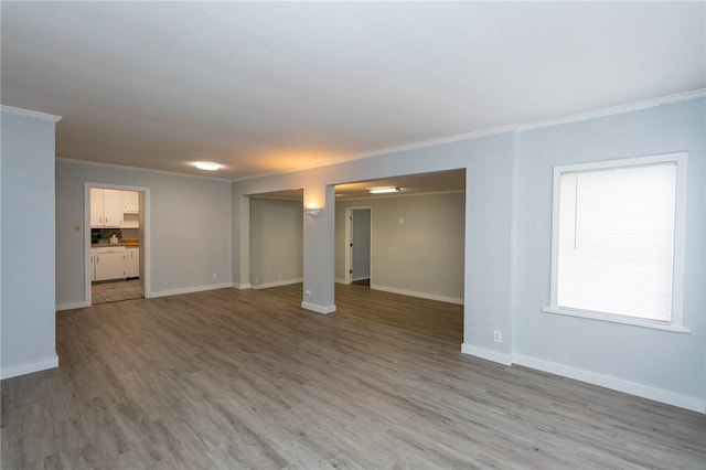 unfurnished room featuring hardwood / wood-style flooring and crown molding