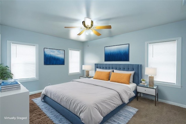 carpeted bedroom with multiple windows and ceiling fan