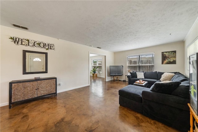 living room featuring baseboards, concrete flooring, a textured ceiling, and visible vents