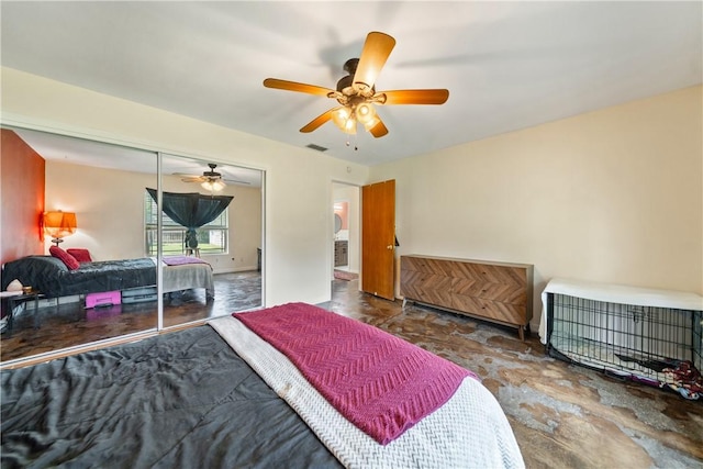bedroom with stone finish flooring, a ceiling fan, and visible vents