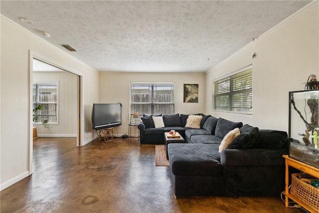 living area featuring a textured ceiling, visible vents, plenty of natural light, and finished concrete floors