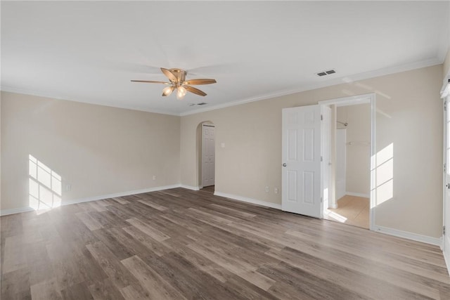 15522 Finistere St, Corpus Christi, TX 78418 - spare room with arched walkways, ceiling fan, wood finished floors, and ornamental molding