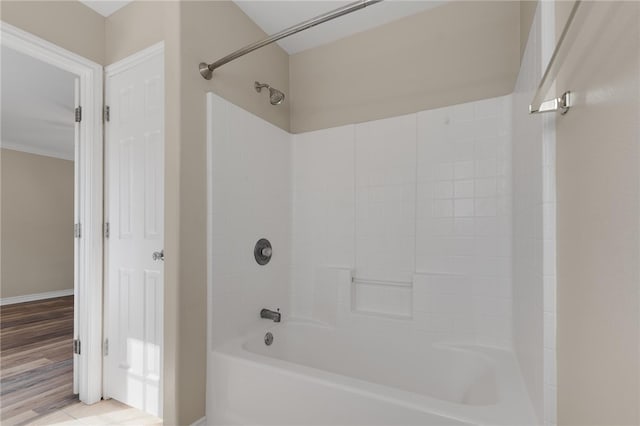 bathroom with hardwood / wood-style floors and  shower combination