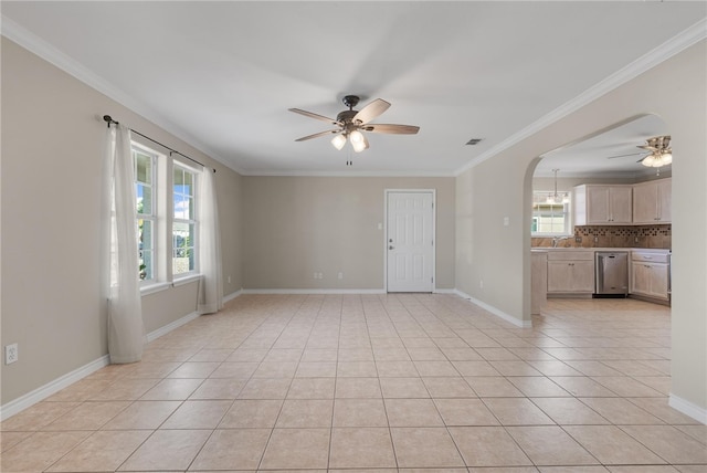 unfurnished room featuring ceiling fan, light tile patterned floors, and crown molding