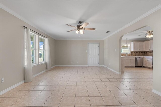 15522 Finistere St, Corpus Christi, TX 78418 - unfurnished living room featuring ceiling fan, light tile patterned floors, arched walkways, and crown molding