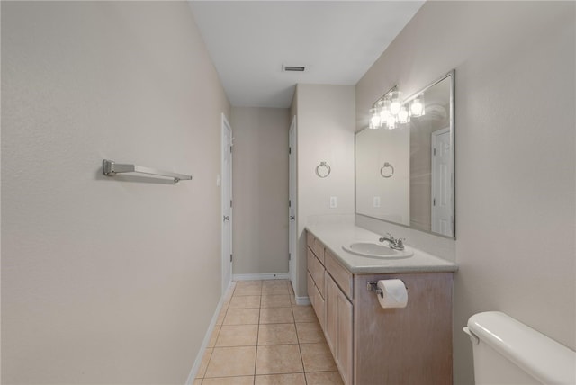 bathroom featuring toilet, vanity, and tile patterned floors