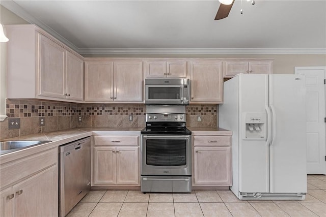 15522 Finistere St, Corpus Christi, TX 78418 - kitchen featuring stainless steel appliances, light brown cabinetry, light tile patterned flooring, ceiling fan, and crown molding