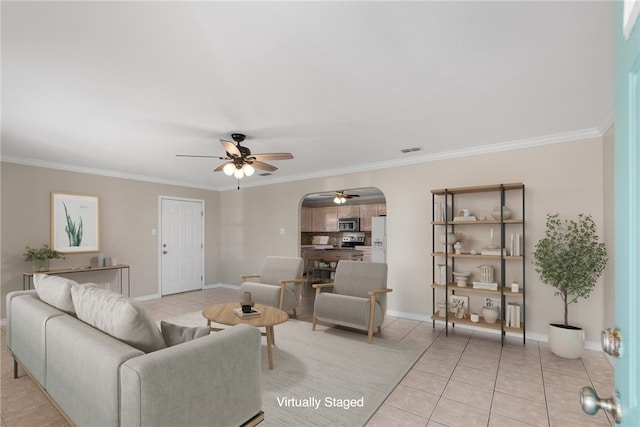 tiled living room with ceiling fan and ornamental molding